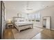 Spacious main bedroom with a large window, ceiling fan, and a sliding barn door at 10401 Maplebrook Way, Highlands Ranch, CO 80126