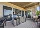 Covered patio with outdoor dining set, grill, and sliding glass doors at 10401 Maplebrook Way, Highlands Ranch, CO 80126