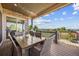 Covered patio with outdoor dining set, stone accents, and scenic views at 10401 Maplebrook Way, Highlands Ranch, CO 80126