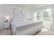 Bright bedroom with white furniture and large windows overlooking the outdoors at 4676 S Dillon Ct # G, Aurora, CO 80015