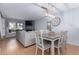 Open floor plan featuring living room and dining area with modern light fixture at 4676 S Dillon Ct # G, Aurora, CO 80015