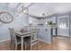 Bright dining area with stylish lighting, a table with seating, and hardwood floors at 4676 S Dillon Ct # G, Aurora, CO 80015