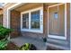 Inviting entrance features brick facade, neutral front door, and charming flower accents at 4676 S Dillon Ct # G, Aurora, CO 80015