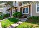 Charming townhome featuring a well-manicured lawn, brick facade, and inviting entrance stairs at 4676 S Dillon Ct # G, Aurora, CO 80015
