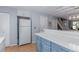 Functional kitchen with a refrigerator, updated countertops, and access to other rooms at 4676 S Dillon Ct # G, Aurora, CO 80015