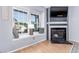 Cozy living room showcasing a fireplace, window seat, and laminate flooring at 4676 S Dillon Ct # G, Aurora, CO 80015