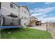 Backyard with trampoline and green turf, set against two-story home at 4792 Coltin Trl, Castle Rock, CO 80104