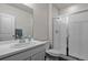 Bright bathroom with a vanity, large mirror, and a glass-enclosed shower at 4792 Coltin Trl, Castle Rock, CO 80104