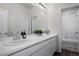 Bathroom featuring a white vanity, white walls, and a large mirror at 4792 Coltin Trl, Castle Rock, CO 80104