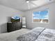 Neutral toned bedroom featuring expansive window with view and dark wood dresser at 4792 Coltin Trl, Castle Rock, CO 80104