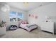 Bright bedroom featuring large window, playful decor and soft, neutral tones at 4792 Coltin Trl, Castle Rock, CO 80104