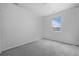 A vacant bedroom with neutral carpet, paint, and a window at 4792 Coltin Trl, Castle Rock, CO 80104