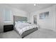 Bedroom featuring tufted headboard, soft, neutral tones and an ensuite bathroom at 4792 Coltin Trl, Castle Rock, CO 80104