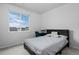 Bright bedroom with a black bed frame, neutral walls, and a large window at 4792 Coltin Trl, Castle Rock, CO 80104