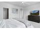 Bright bedroom featuring neutral tones, modern dresser, and attached bathroom and closet at 4792 Coltin Trl, Castle Rock, CO 80104