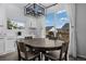 Bright dining area with a large table, sliding glass doors to the deck, and modern light fixture at 4792 Coltin Trl, Castle Rock, CO 80104