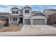Charming two-story home with a well-manicured lawn and a two-car garage at 4792 Coltin Trl, Castle Rock, CO 80104