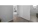 Hallway leading to other rooms, showcasing wood and tiled floors at 4792 Coltin Trl, Castle Rock, CO 80104