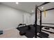 Finished home gym with weight lifting rack, bench, weights, and rubber flooring at 4792 Coltin Trl, Castle Rock, CO 80104