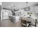 Modern kitchen with white cabinets, an island with seating, and stainless steel appliances at 4792 Coltin Trl, Castle Rock, CO 80104