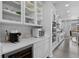 Modern kitchen with white cabinetry, stainless steel appliances, wine cooler, and ample counter space at 4792 Coltin Trl, Castle Rock, CO 80104