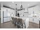 Stylish kitchen featuring white cabinets, a center island, and modern lighting fixtures at 4792 Coltin Trl, Castle Rock, CO 80104