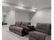 Spacious living room features plush couches, a side table, and a projector at 4792 Coltin Trl, Castle Rock, CO 80104