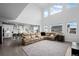 Expansive living room with an open kitchen, high ceilings, and ample natural light at 4792 Coltin Trl, Castle Rock, CO 80104
