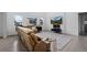 Bright and airy living room featuring a plush sofa, modern decor, and large windows at 4792 Coltin Trl, Castle Rock, CO 80104