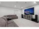 Large living room with a projector screen, plush couches, and recessed lighting at 4792 Coltin Trl, Castle Rock, CO 80104