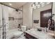 Bathroom features a shower-tub combination, vanity with granite countertop and a decorative mirror at 30722 Eldora Ct, Evergreen, CO 80439