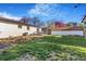 Lush backyard featuring a wooden deck, well-kept grass, and a shed offering an ideal outdoor space at 135 Garnet St, Broomfield, CO 80020