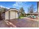 Spacious backyard featuring a wooden deck, storage shed, and table set up for outdoor dining at 135 Garnet St, Broomfield, CO 80020
