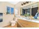 A well-lit bathroom with a double vanity, gold fixtures, and a large window offers comfort and style at 135 Garnet St, Broomfield, CO 80020