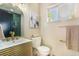 This bathroom has a stylish vanity with gold hardware and a tiled shower, offering a modern and elegant space at 135 Garnet St, Broomfield, CO 80020