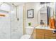 Stylish bathroom with a glass-enclosed shower, modern vanity, and gold fixtures at 135 Garnet St, Broomfield, CO 80020