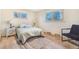 A bright bedroom with large windows, hardwood floors, and a stylish rug provides a welcoming atmosphere at 135 Garnet St, Broomfield, CO 80020