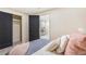 Modern bedroom featuring plush bedding, dark doors, and closet, offering a comfortable and stylish space at 135 Garnet St, Broomfield, CO 80020