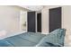 Comfortable bedroom showcasing dark doors, closet, and neutral decor, creating a relaxing ambiance at 135 Garnet St, Broomfield, CO 80020