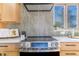 Close up of a modern kitchen with stainless steel appliances and stylish backsplash at 135 Garnet St, Broomfield, CO 80020