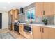 Modern kitchen with stainless steel appliances, light wood cabinets, and stylish backsplash at 135 Garnet St, Broomfield, CO 80020