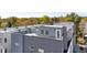 View of rooftop decks with modern gray siding and white trim details on a bright, sunny day at 4395 Zuni St, Denver, CO 80211