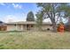 Expansive backyard featuring a playset and a well-maintained lawn, perfect for outdoor enjoyment at 3292 S Wabash Ct, Denver, CO 80231