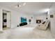 Finished basement area with stone fireplace, large television, comfortable seating, and washer/dryer at 3292 S Wabash Ct, Denver, CO 80231