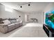 Finished basement featuring a large TV, comfortable seating, and ample space at 3292 S Wabash Ct, Denver, CO 80231