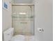 Bathroom featuring a glass-enclosed shower with white subway tile, a shower head, and a toilet at 3292 S Wabash Ct, Denver, CO 80231