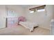 Bright bedroom with a single bed, storage unit, and a window providing natural light at 3292 S Wabash Ct, Denver, CO 80231