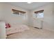 Bright bedroom with a bed, a dresser, two windows, and plush carpet at 3292 S Wabash Ct, Denver, CO 80231