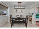 Elegant dining room featuring modern lighting, a dark wood table, and a neutral color palette at 3292 S Wabash Ct, Denver, CO 80231