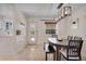 Bright dining area with a modern light fixture, seating for six, and a view to the backyard at 3292 S Wabash Ct, Denver, CO 80231